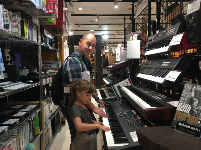 Taras testing synthesisers at the Yamaha Ginza Flagship Store in Japan